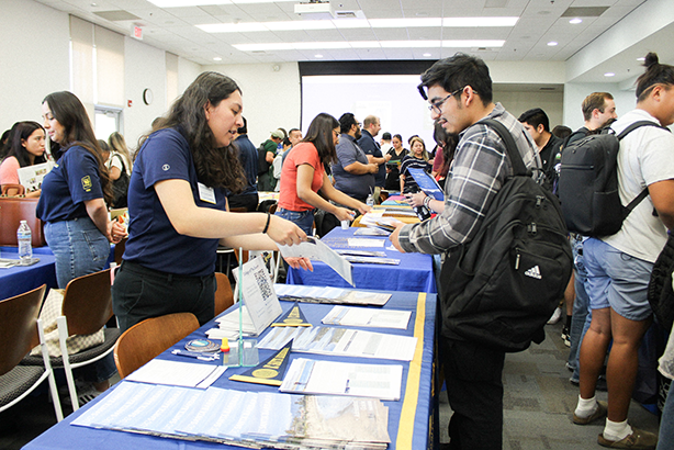 Students speaking with counselor during transfer fair