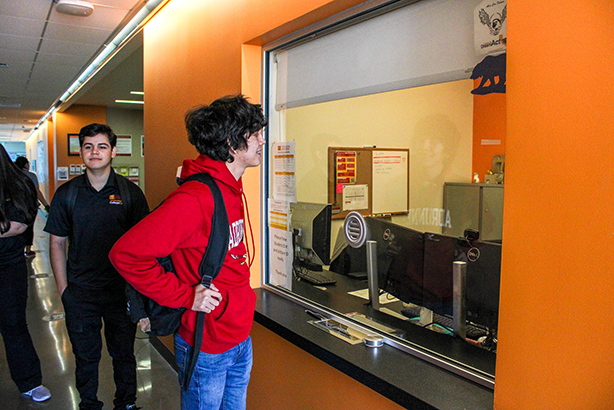 student standing at office window