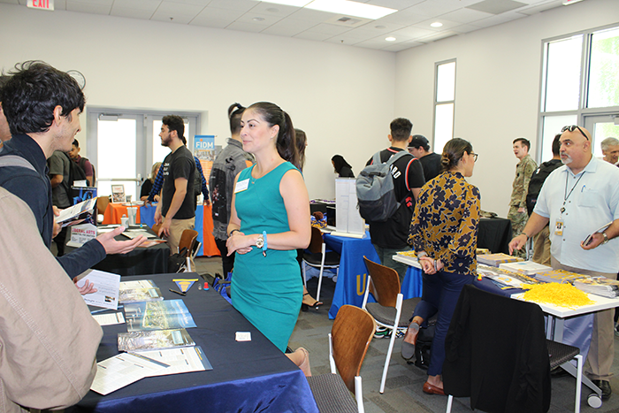 Students speaking with transfer advisors from universities